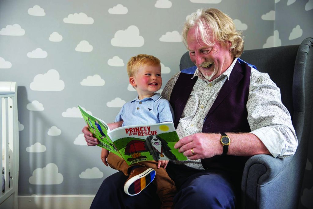 Princey the dog Norman Macdonald reading his new book, Princey To The Rescue to his grandson, Jude McGhee who had inspired him to write the story