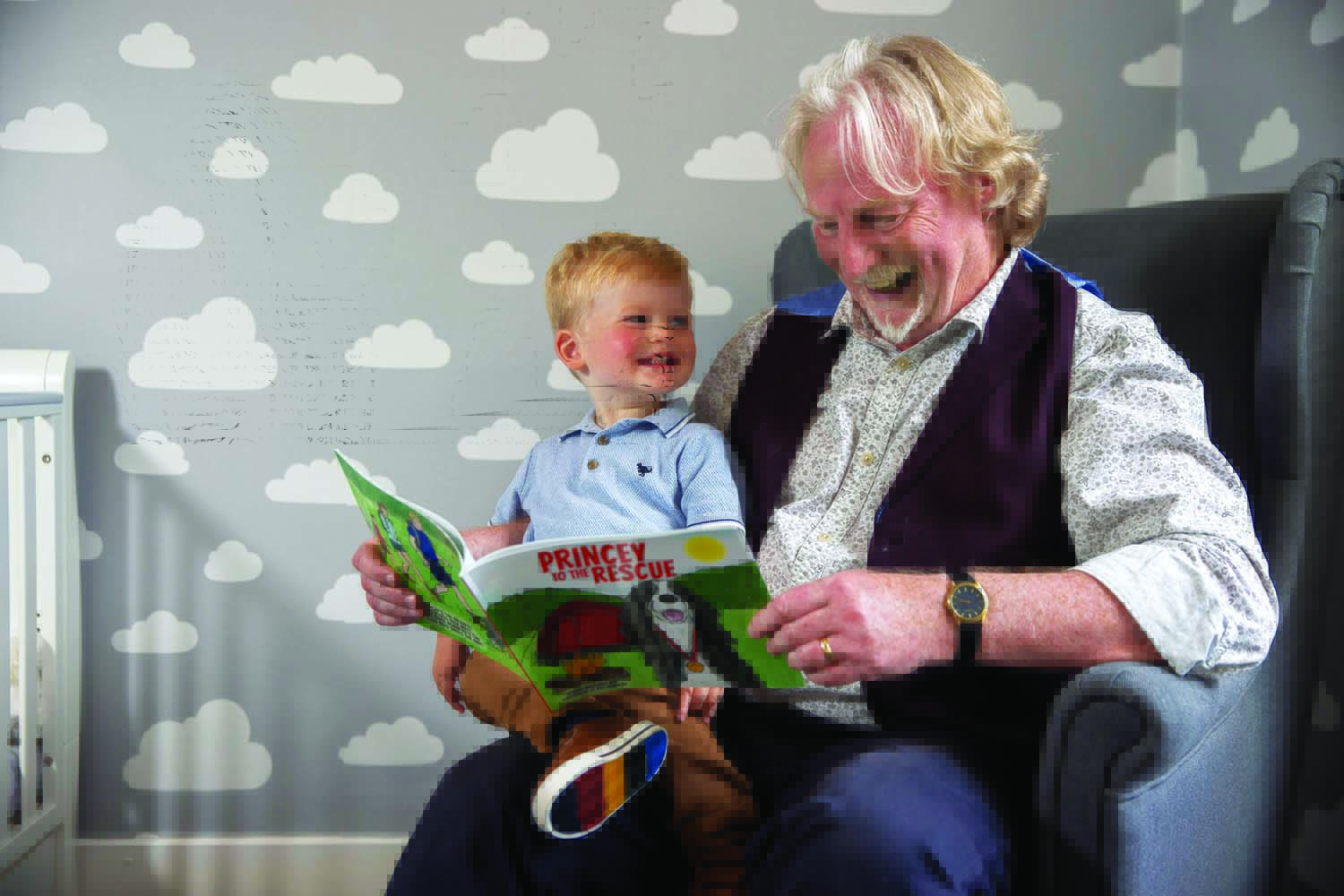 Princey the dog Norman Macdonald reading his new book, Princey To The Rescue to his grandson, Jude McGhee who had inspired him to write the story